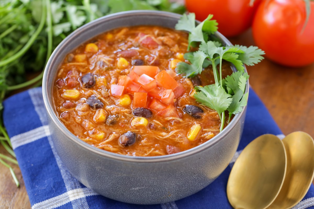 Chicken Taco Soup served in a gray bowl and topped with fresh lime slices.