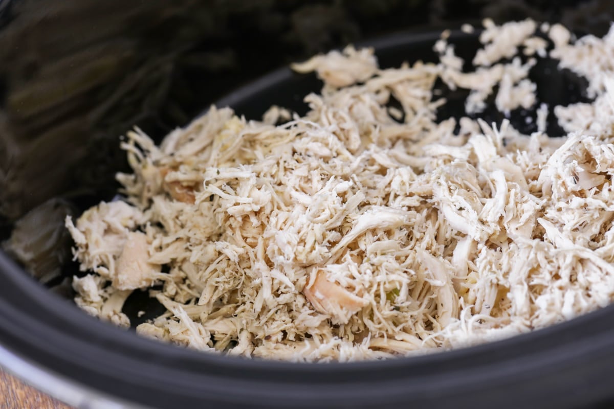 Shredded chicken in slow cooker for taco soup.