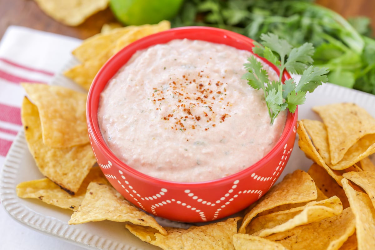 Cream cheese salsa dip served in a bowl with tortilla chips.