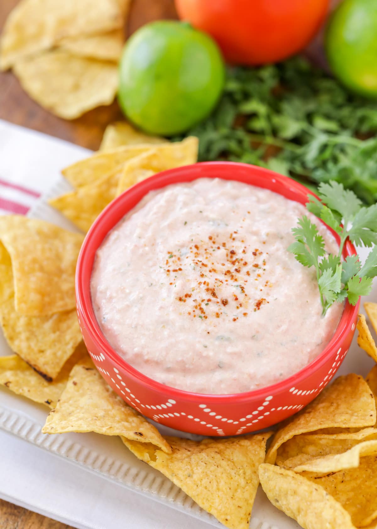Cream cheese and salsa dip served in a bowl with tortilla chips.