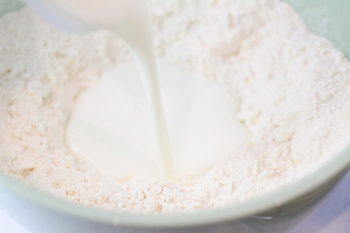 Combining wet and dry ingredients in a mint bowl.