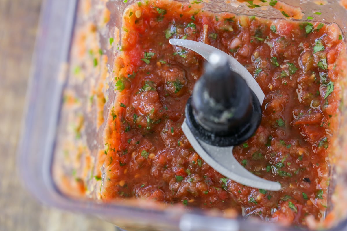 Blending homemade salsa to make cream cheese salsa dip.