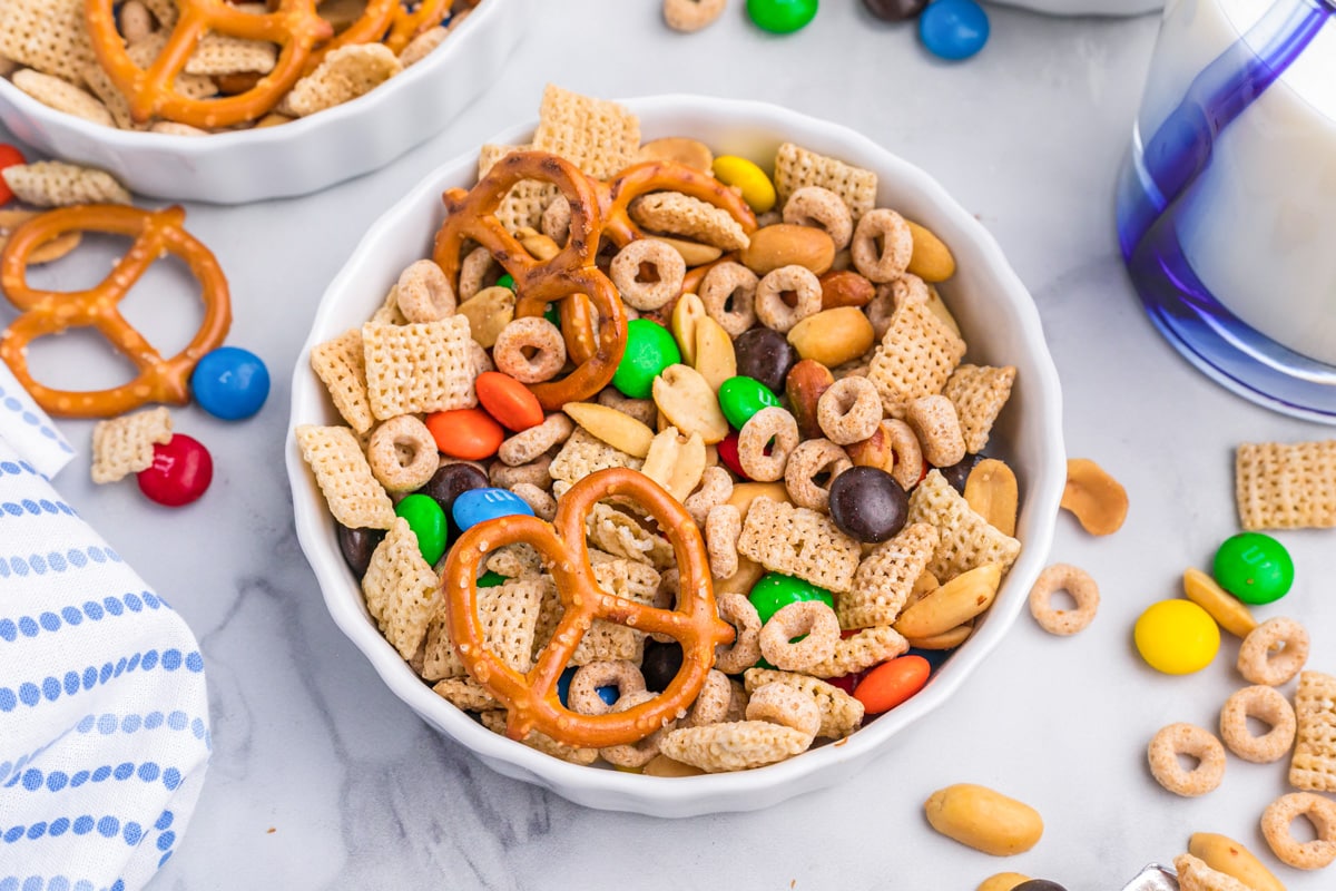 A white bowl filled with sweet and salty chex mix.