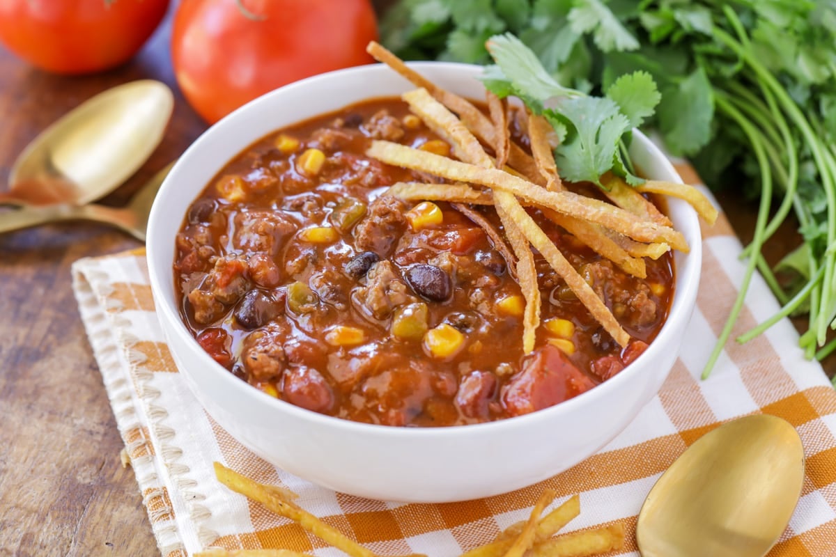 Taco Soup recipe with tortilla strips in a white bowl.