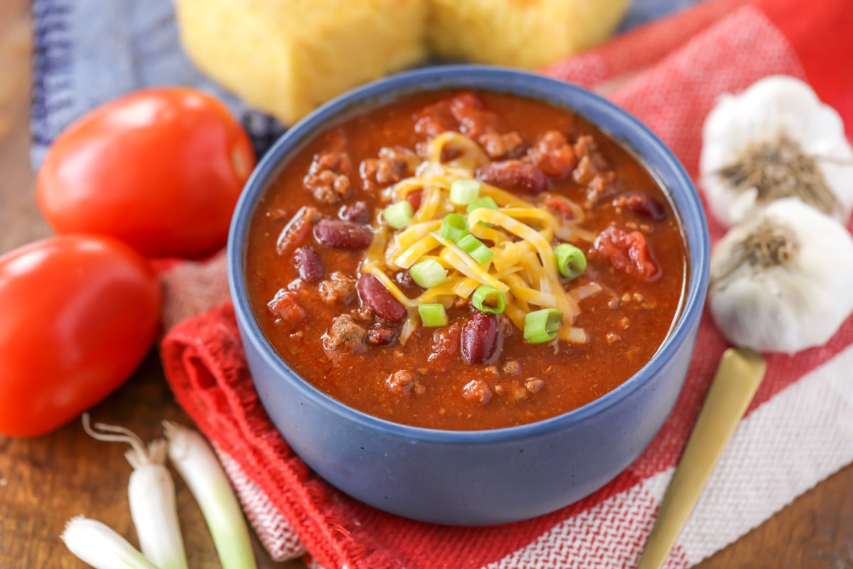 A blue bowl filled with chili.