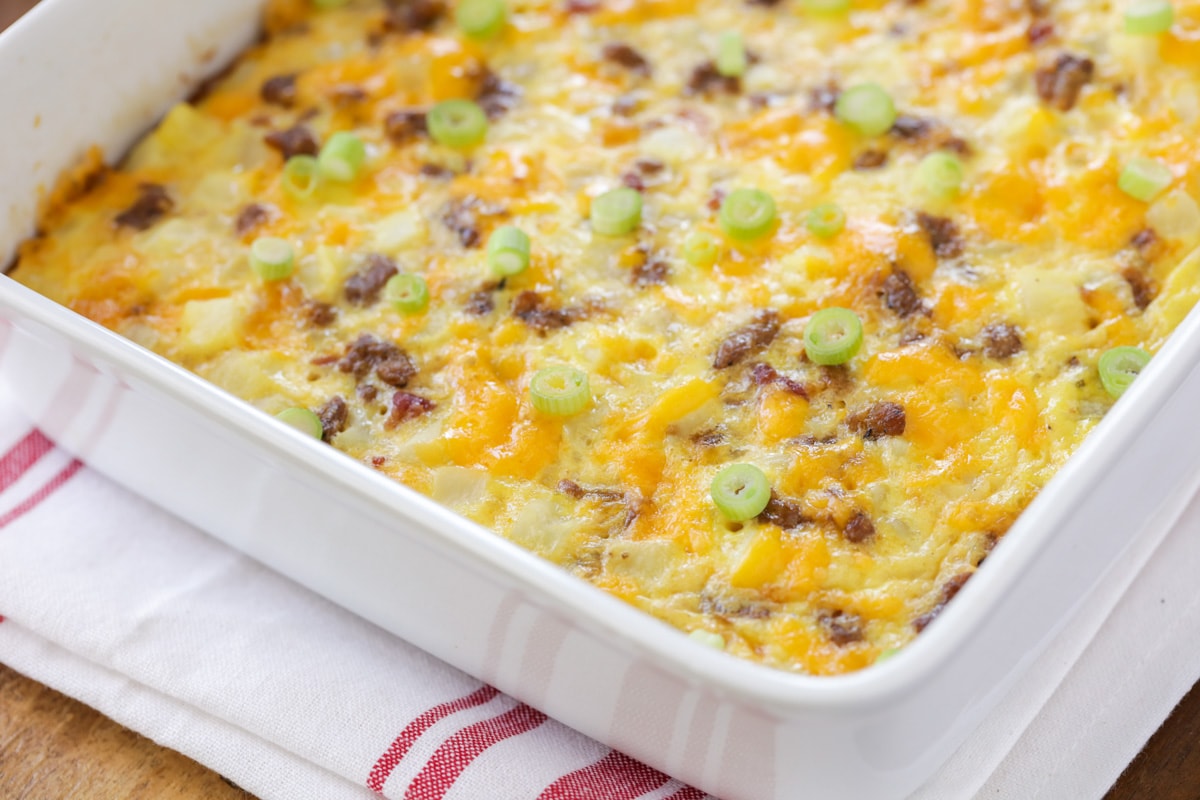 Cheesy Breakfast Potato Casserole baked in a dish and topped with green onions.