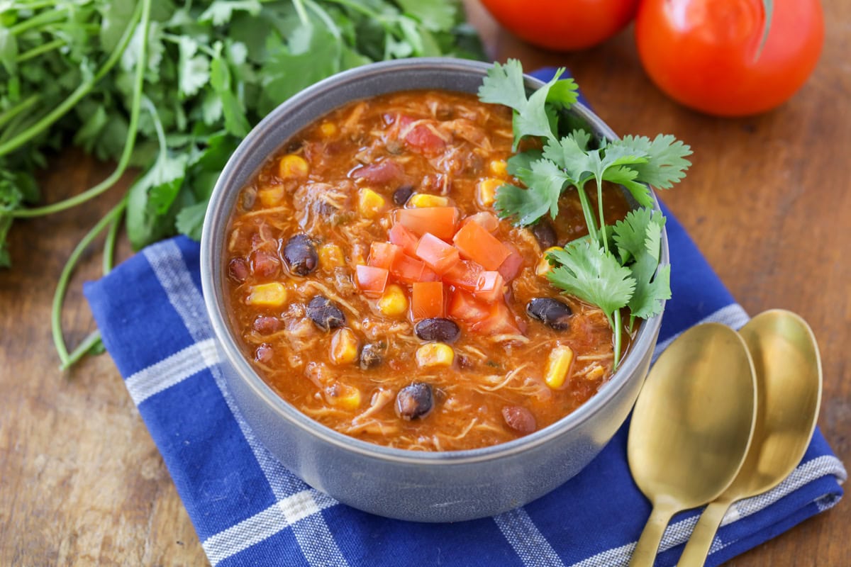 A bowl of chicken taco soup topped with cilantro.