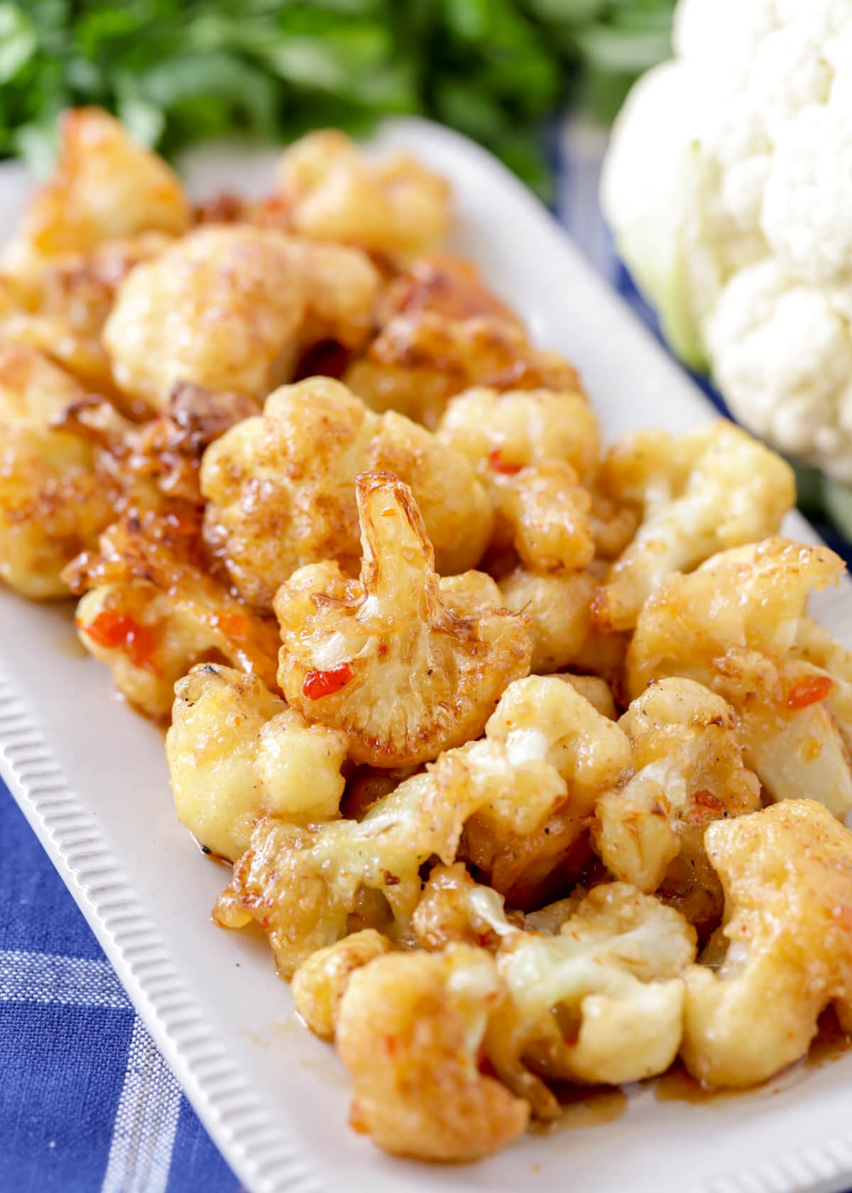 Close up of a white platter filled with fried cauliflower.