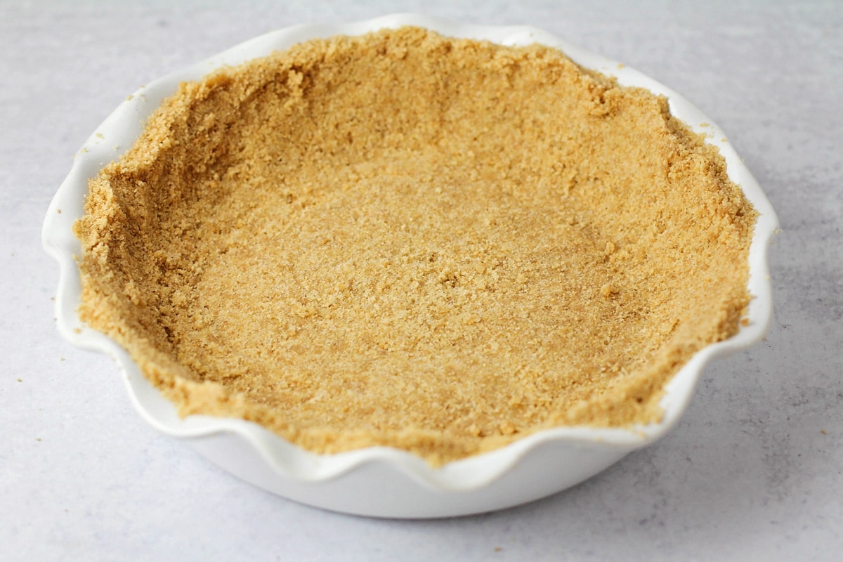 Pressed graham cracker crust into the pie dish.