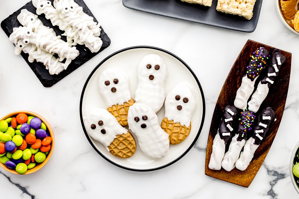 Nutter butter ghosts and other halloween treats on a kitchen counter.