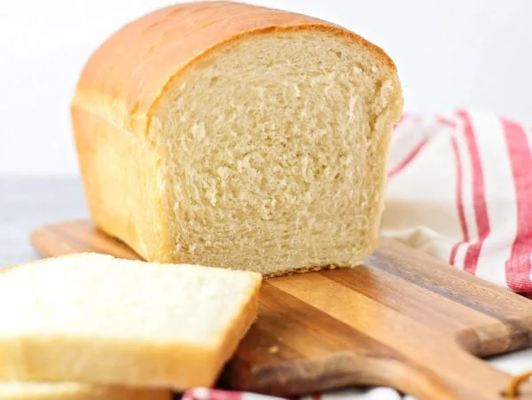 A slice cut out of our classic bread recipe on cutting board.