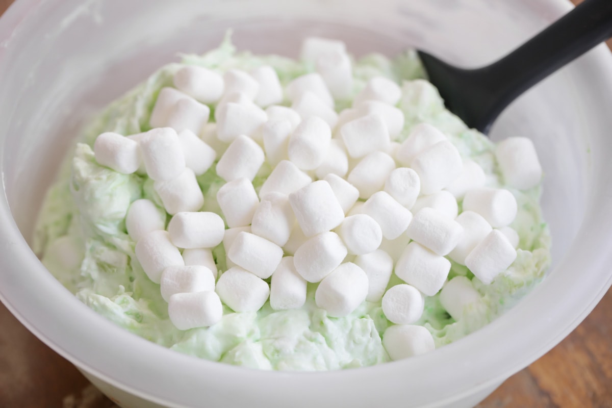 Bowl of Pistachio pudding salad mix with marshmallows.