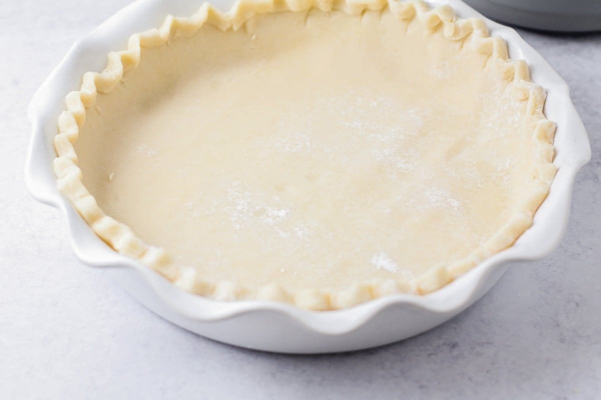 A crust in a white pie pan.