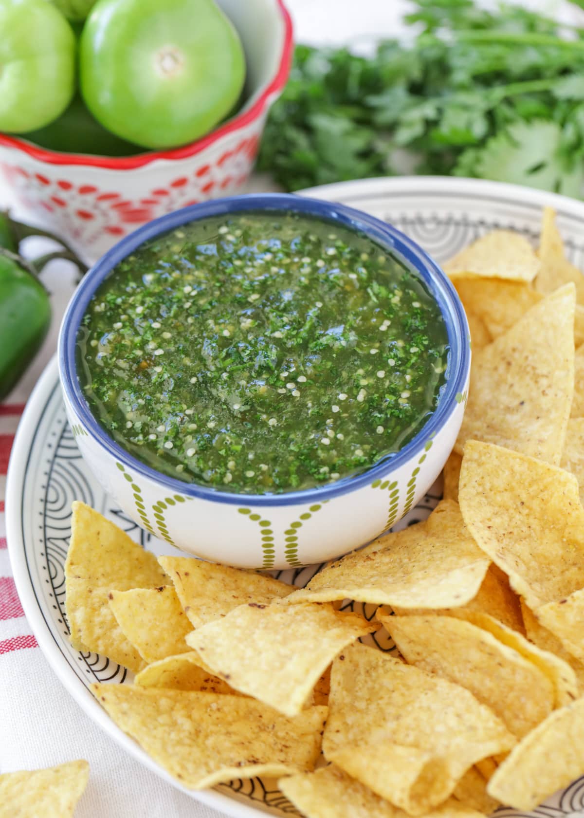 Sweet Salsa Verde recipe aka green salsa in a bowl with tortilla chips.