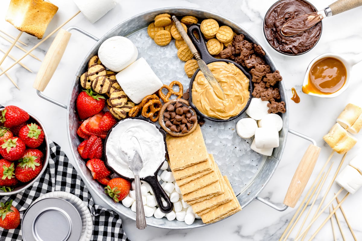 Filling in the S'mores Charcuterie Board with sweets and treats.