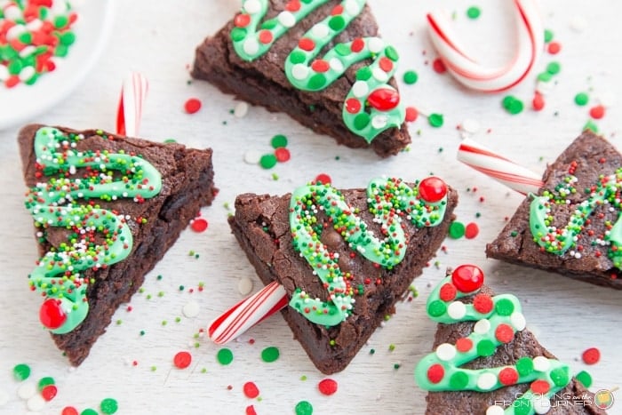 Decorate Christmas tree brownies on a kitchen counter.