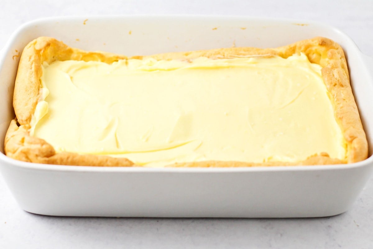 Layers of cream puff cake in a baking dish.