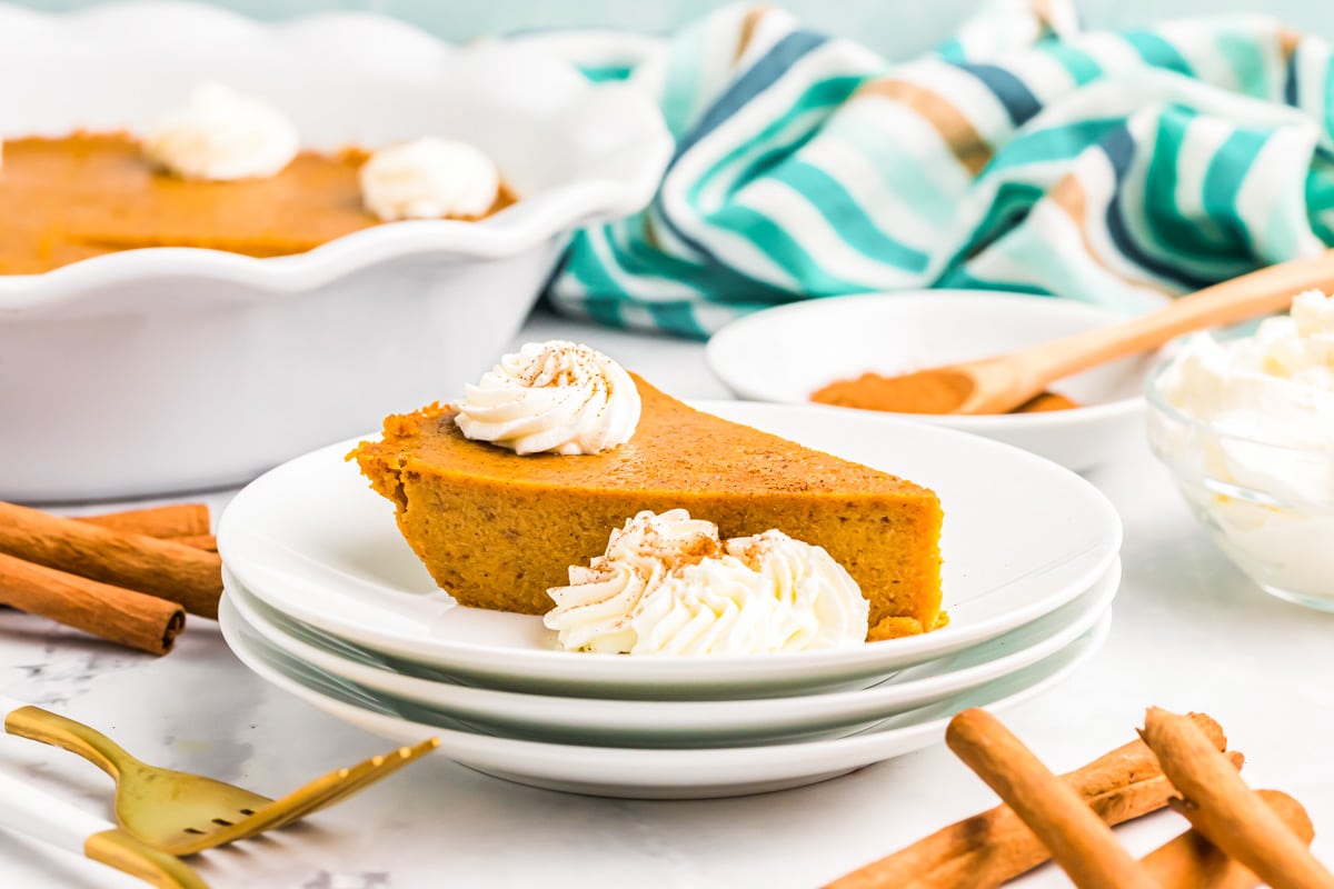 A slice of crustless pumpkin pie topped with whipped cream.