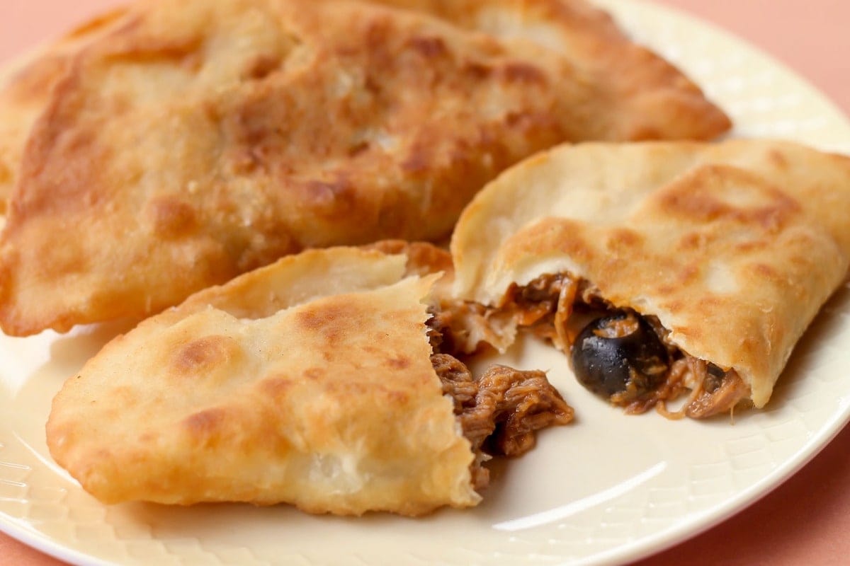 Empanadas on a white plate.