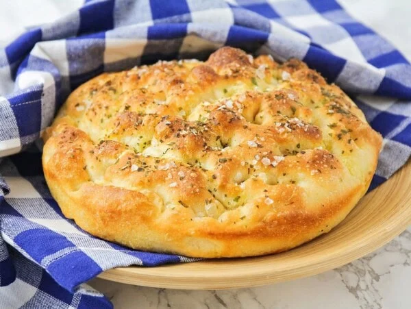 Focaccia bread recipe in dish towel.