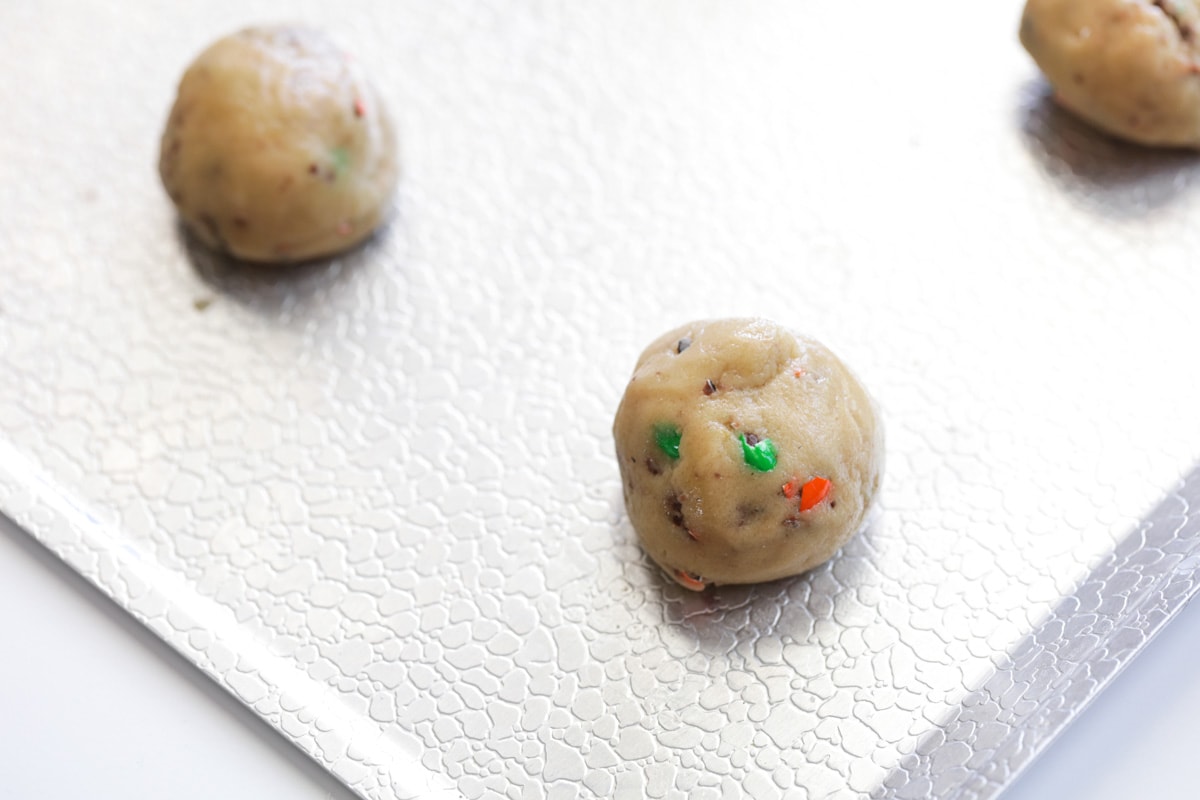Halloween cookie dough balls on a cookie sheet ready for baking.