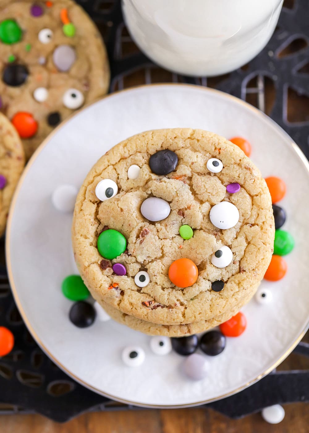 Spooky Halloween cookie recipe stacked on a white plate and topped with candy eyes.