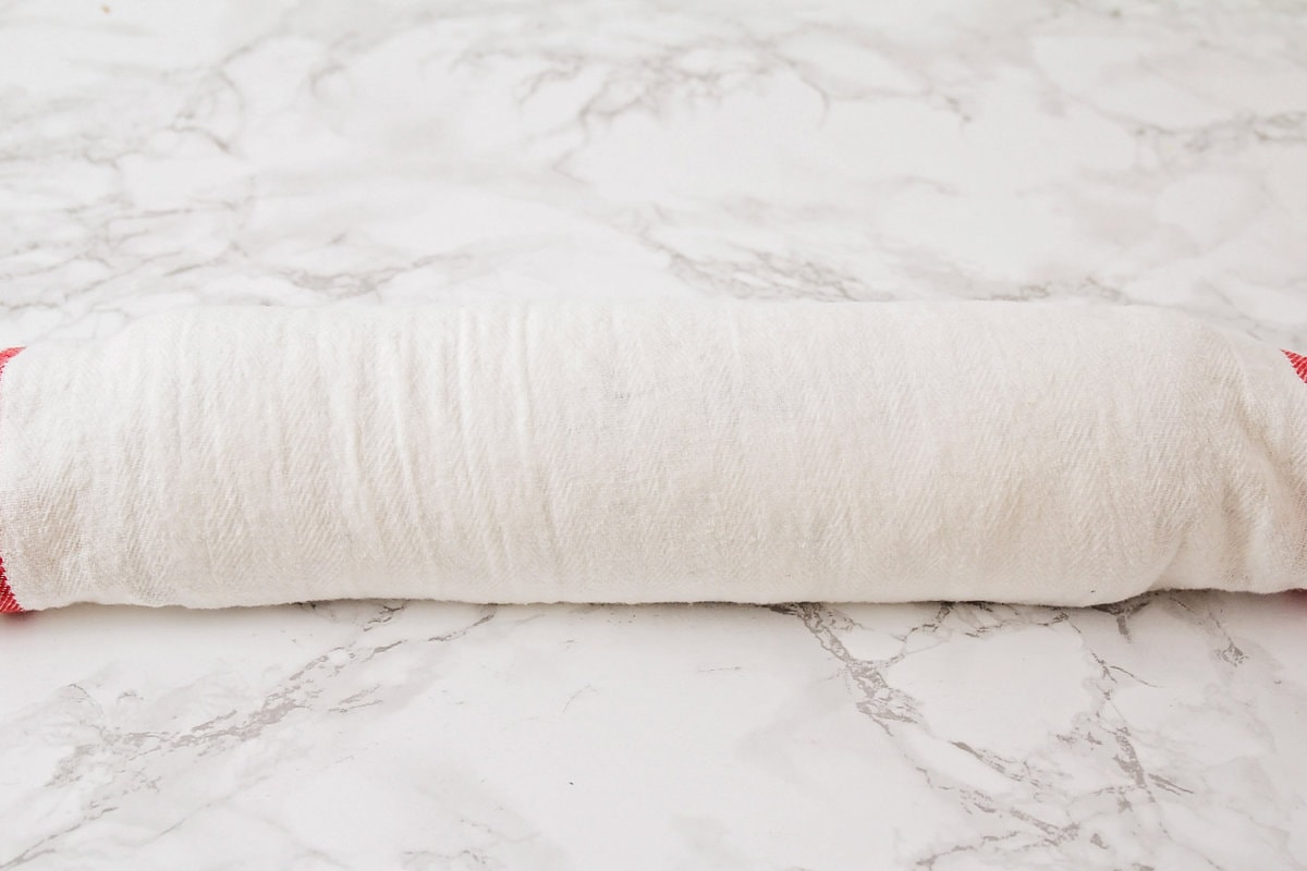 Pumpkin roll wrapped in a tea towel.