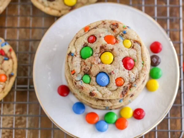 M&M cookie recipe stacked on a plate.