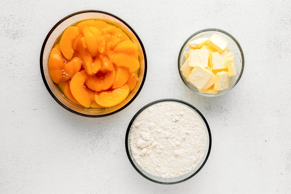 Peach dump cake ingredients in bowls.