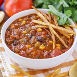 Taco soup served with fresh cilantro and tortilla strips.