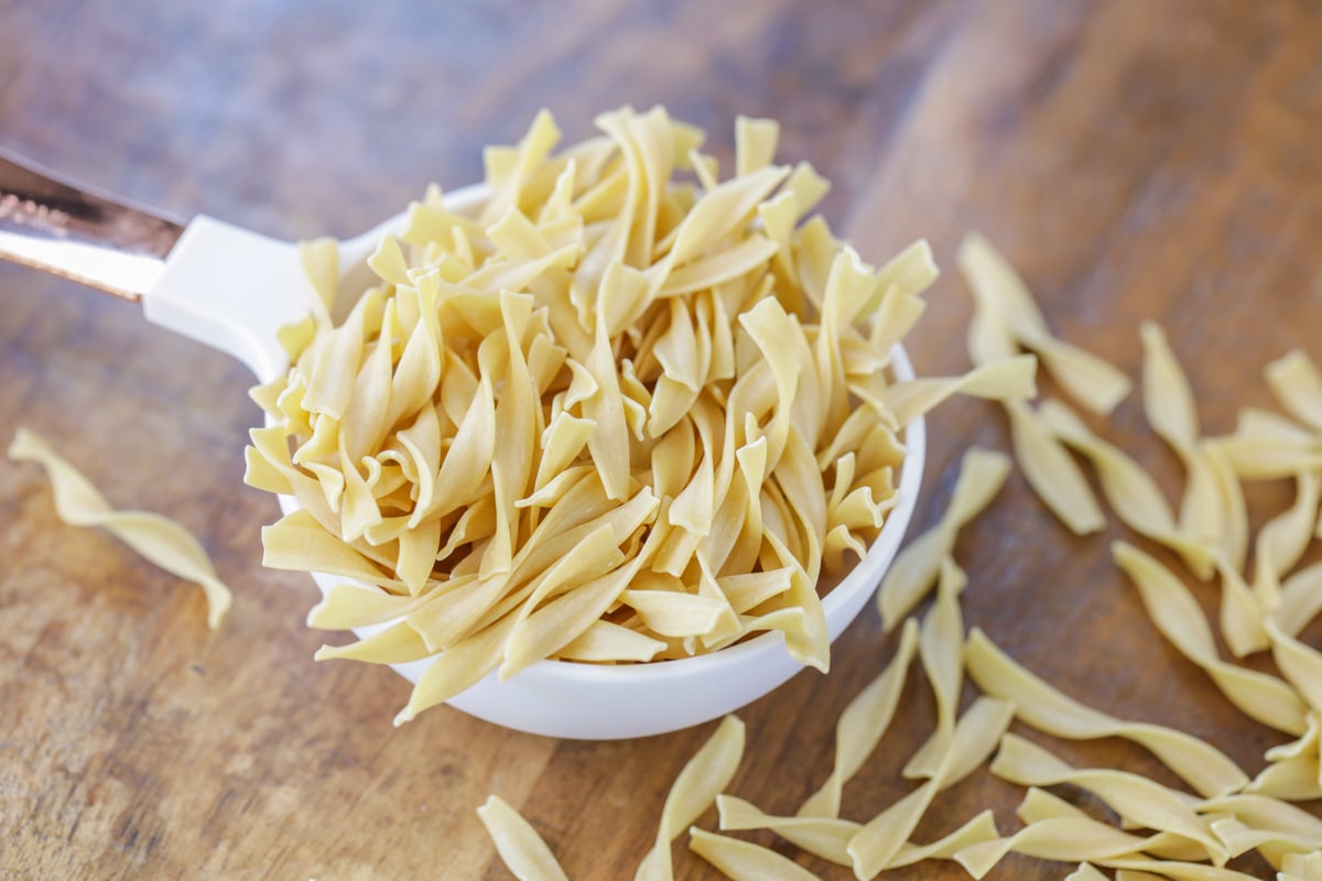 Dried pasta in a measuring cup to use in turkey soup.