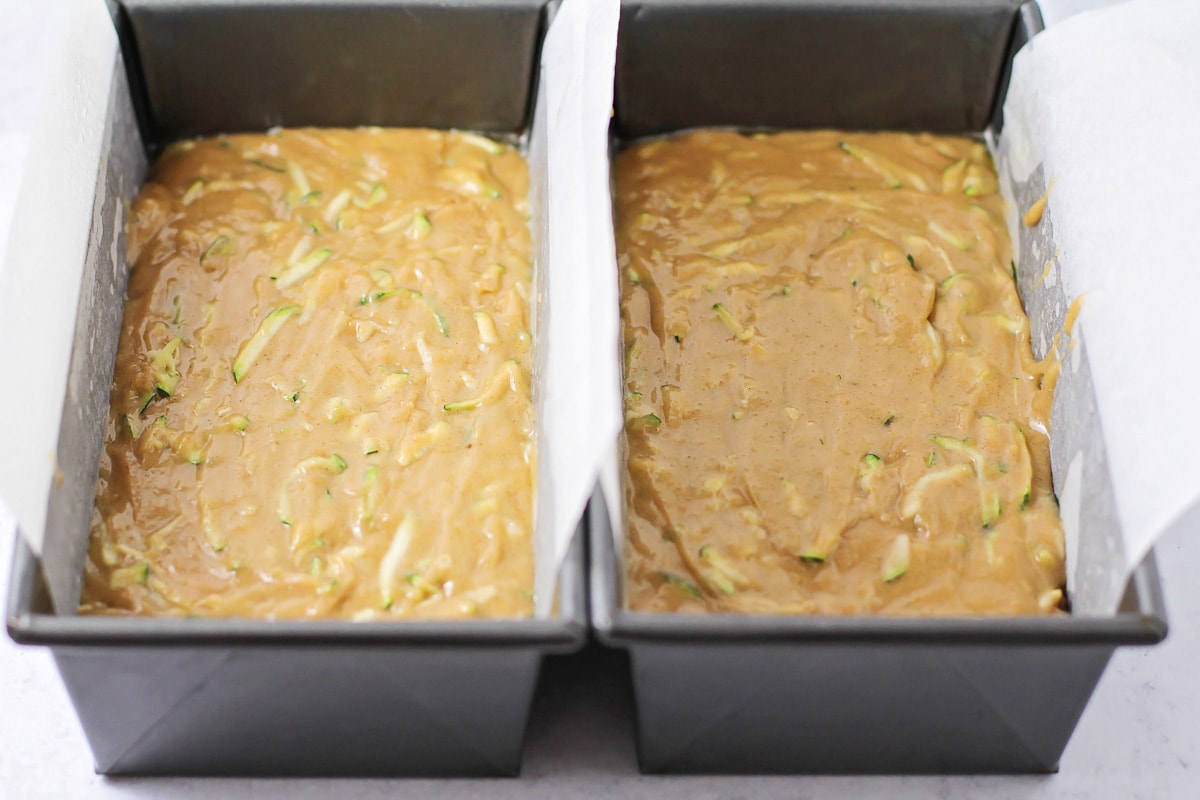 Easy zucchini bread batter poured into bread pans.