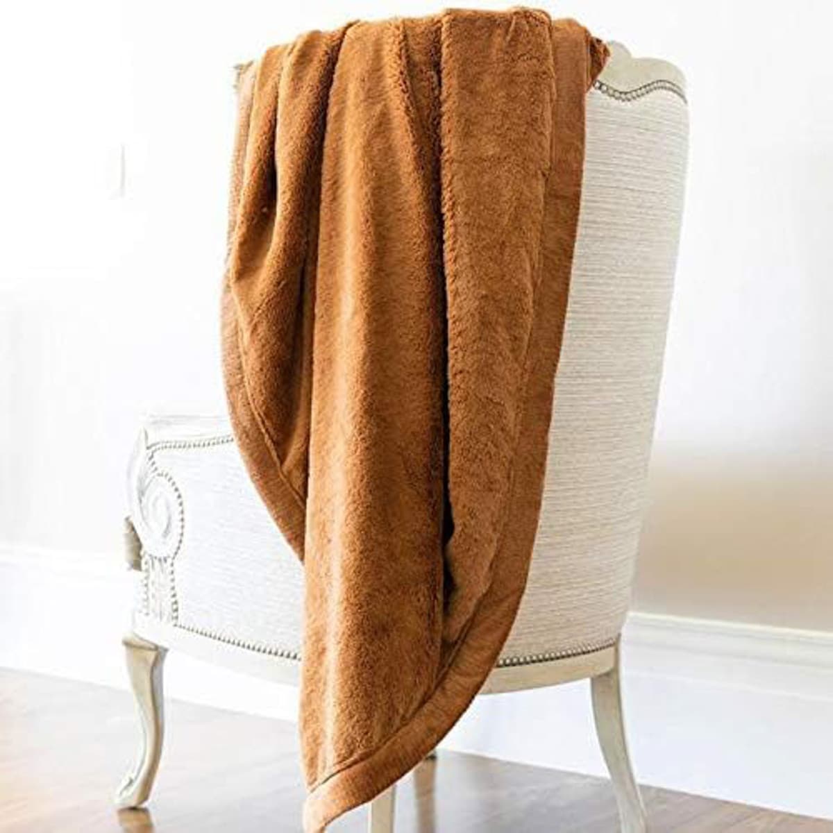 Brown blanket hanging over the back of a chair.