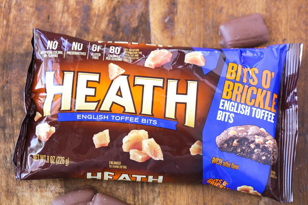 A package of Heath English Toffee Bits on a wood surface.
