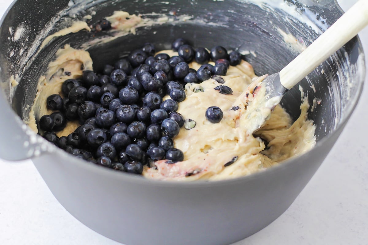Batter for blueberry bread recipe being mixed in a grey bowl.