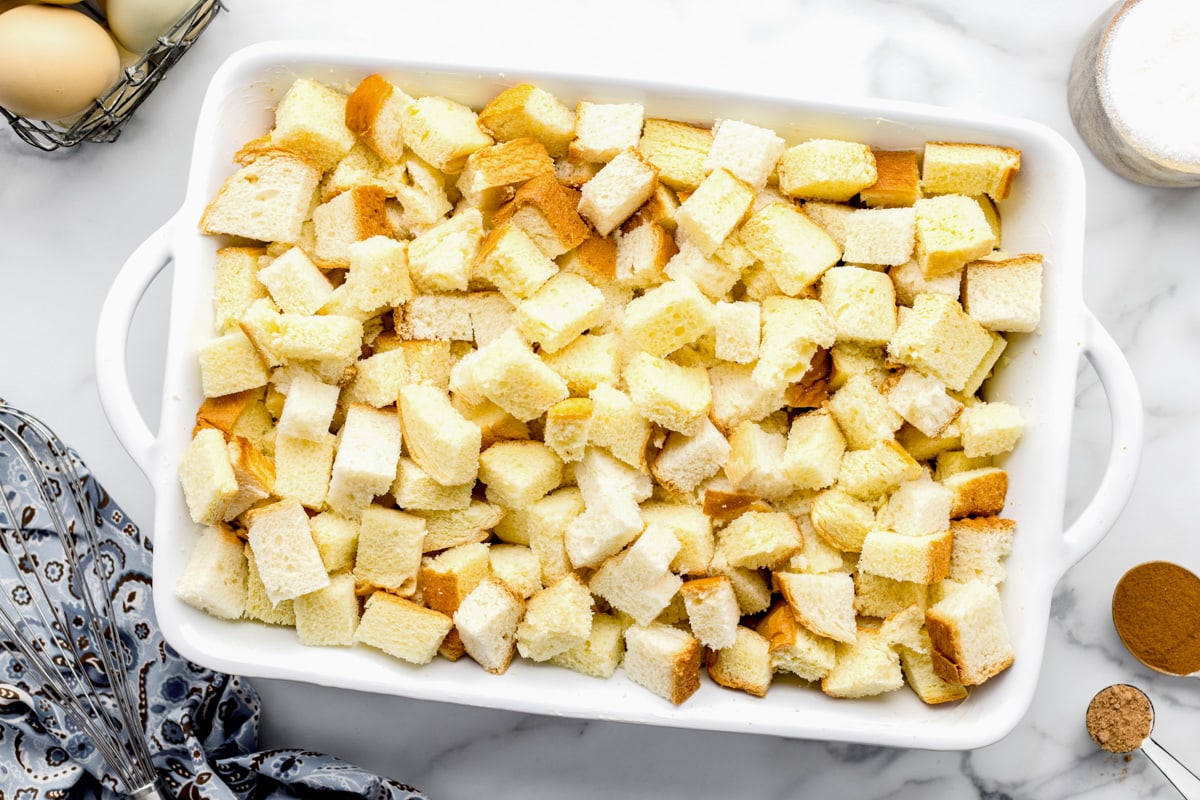 Cubed bread in a pan for making easy bread pudding.