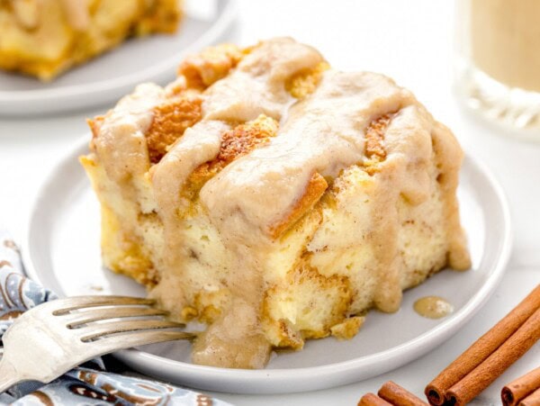 Slice of bread pudding on a white plate.
