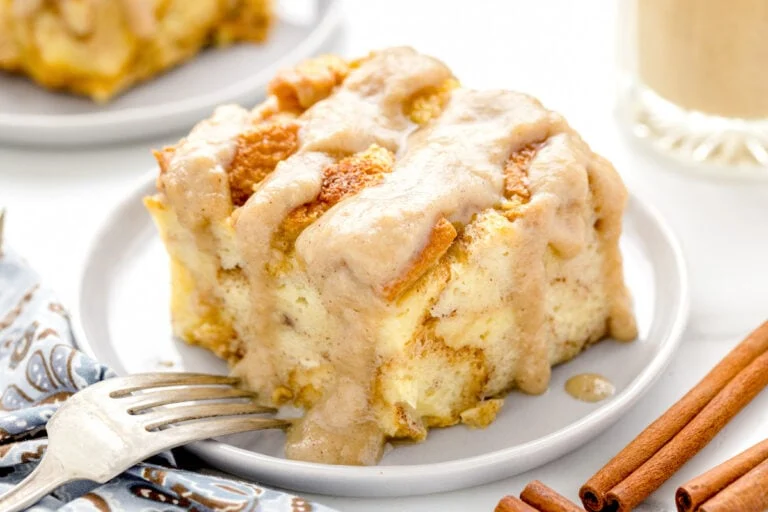 Slice of bread pudding on a white plate.
