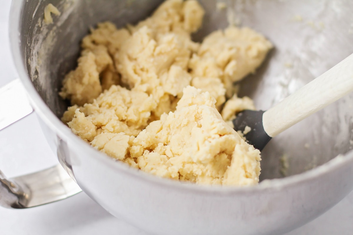 Mixing dough for butter cookies in a bowl.