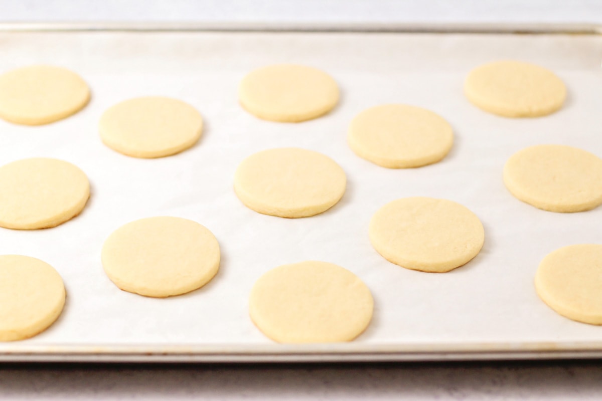 Fresh baked butter cookies on a cookie sheet.