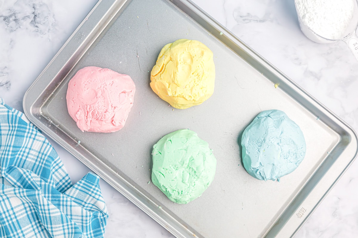 Four balls of different colored butter mint batter.
