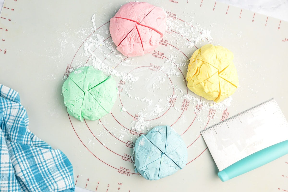 Dividing the four different colored balls of butter mint dough.