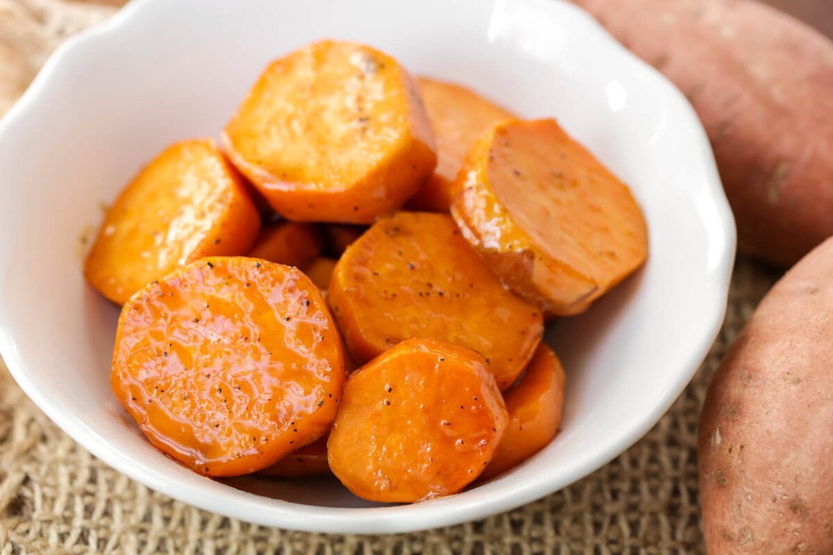 Candied Sweet Potatoes recipe served in white bowl.