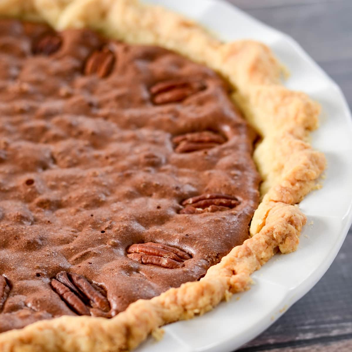 Chocolate Pecan Pie in a white pie pan.