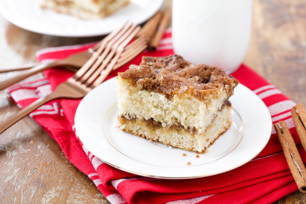 A slice of easy homemade coffee cake served on a white plate with a fork.