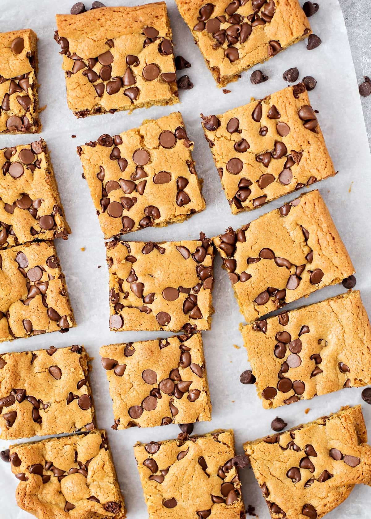 Cut up cookie bars on a sheet of parchment paper.