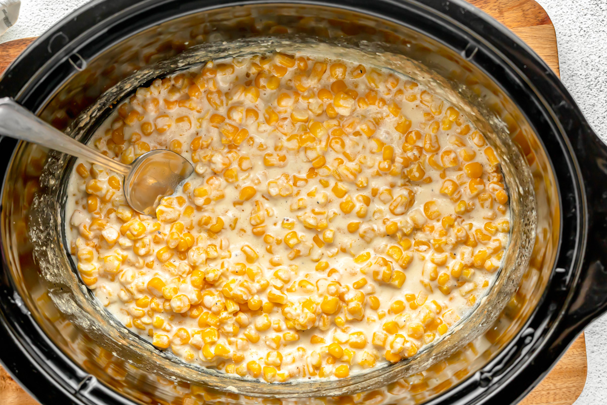 Making crockpot creamed corn in a slow cooker.