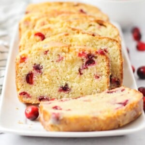 Slices of cranberry orange bread on a white plate.