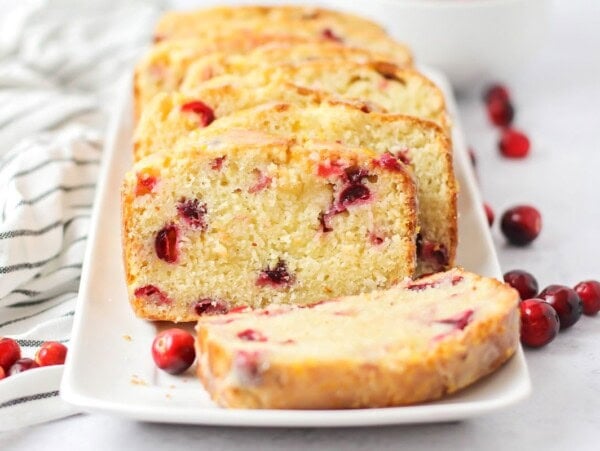 Slices of cranberry orange bread on a white plate.