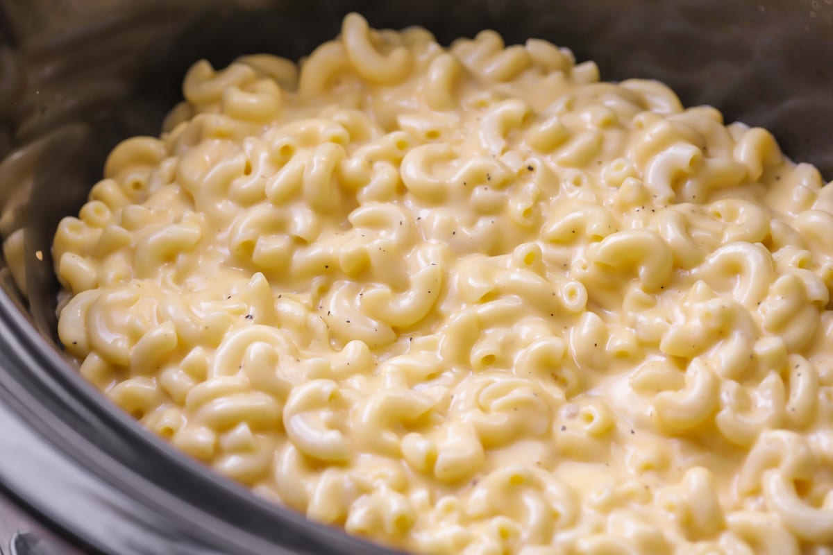 A crock pot filled with mac and cheese.